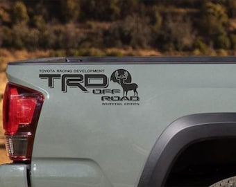 May include: A gray pickup truck with a black "TRD Off Road Whitetail Edition" decal on the tailgate. The decal features a stylized deer with antlers.
