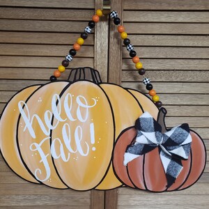 Letrero para colgar en la puerta con diseño de calabaza otoñal