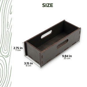 May include: A dark brown wooden storage box with cut-out handles. The box is 9.84 inches (25 cm) long, 3.15 inches (8 cm) wide, and 2.75 inches (7 cm) high. The word "SIZE" is printed in green at the top.