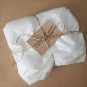 May include: A set of three ceramic mugs with a speckled, matte finish. The mugs are in shades of cream, light gray, and dark gray. Each mug has a simple, minimalist design and a rounded handle. Perfect for coffee or tea.