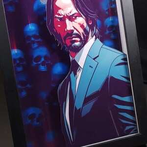 May include: Framed art print featuring a stylized illustration of a man in a suit. The artwork has a dark color palette with a background of blue skulls. The man is depicted with a stern expression, wearing a teal suit and a white shirt.