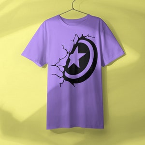 May include: A purple t-shirt with a black graphic of a star inside a circle, appearing to break through the fabric.