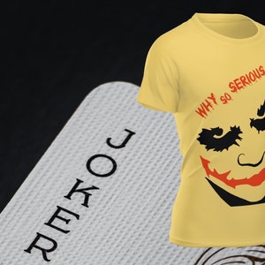 May include: A yellow t-shirt with a black and red graphic of the Joker from the Batman comics. The graphic includes the Joker's face and the text "WHY SO SERIOUS?"
