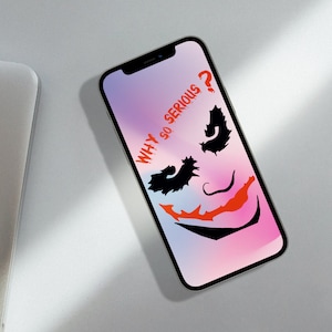 May include: A smartphone with a pink and blue gradient background. The screen displays a black and white silhouette of the Joker's face with the text "WHY SO SERIOUS?" in red.