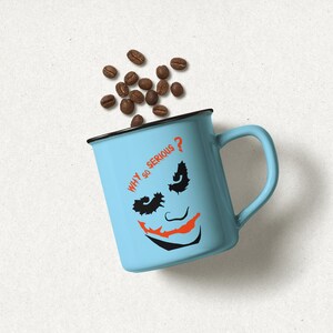 May include: A light blue mug with a black rim and handle. The mug has a black and orange Joker face with the text "WHY SO SERIOUS?" printed on it. Coffee beans are scattered around the mug.
