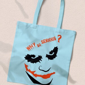 May include: Light blue canvas tote bag with a black and orange Joker face graphic and the text "WHY SO SERIOUS?" in red.