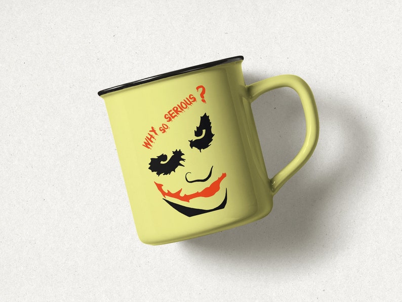May include: A yellow ceramic mug with a black rim and handle. The mug features a black and white illustration of the Joker from Batman with the text "WHY SO SERIOUS?" in red.
