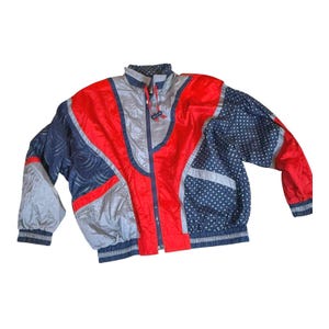 May include: A vintage windbreaker jacket in red, gray, and navy blue. The jacket features a color-blocked design with a zipper closure, a stand-up collar, and elastic cuffs. The sleeves have a polka dot pattern.