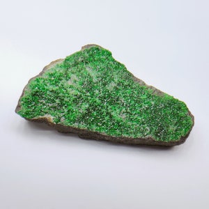 Uvarovite (green Garnet) crystals coating matrix from the Urals, Russia