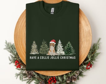May include: A dark green t-shirt with a white graphic of a Collie dog wearing a Santa hat in front of a row of Christmas trees. The text "HAVE A COLLIE JOLLIE CHRISTMAS" is printed below the graphic.