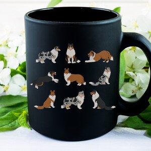 May include: Black ceramic coffee mug with a white design of various blue merle and sable rough collie dogs in different poses.
