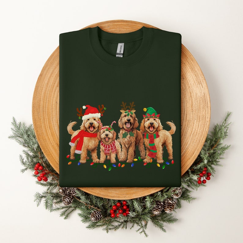 May include: Four golden doodle dogs wearing festive Christmas attire, including Santa hats, reindeer antlers, and elf hats, with a string of Christmas lights in front of them. The dogs are standing on a green background.