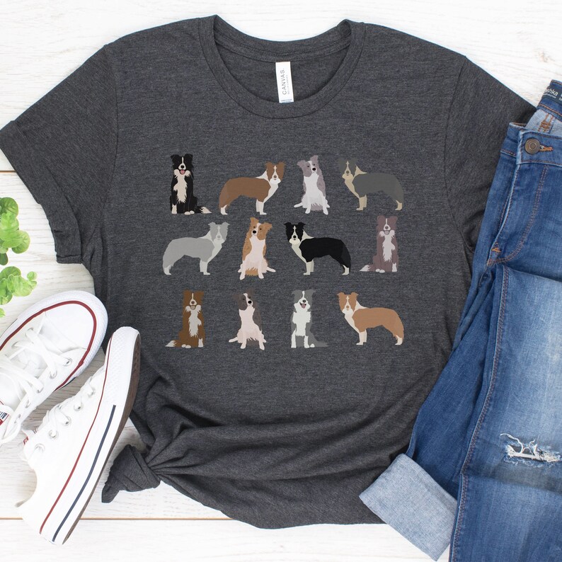 Pode incluir: Uma camiseta cinza escura com um padr&atilde;o de 12 border collies de diferentes cores. Os collies est&atilde;o todos em poses diferentes, alguns est&atilde;o sentados, outros em p&eacute; e outros correndo.