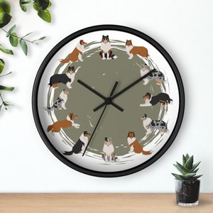 May include: A round wall clock with a green background and a white circle in the center. The circle is surrounded by 12 images of Collie dogs in various poses. The clock hands are black and the numbers are not visible.