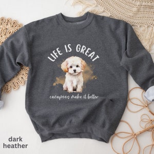 K&ouml;nnte beinhalten: Dunkelgrauer Sweatshirt mit einem wei&szlig;en Aquarellbild eines Cavapoo-Welpen. Der Text "Life is Great, cavapoos make it better" ist auf dem Sweatshirt aufgedruckt.