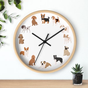 May include: A white clock face with black hands and a brown wooden frame. The clock face features a variety of dog breeds in different poses around the clock face.