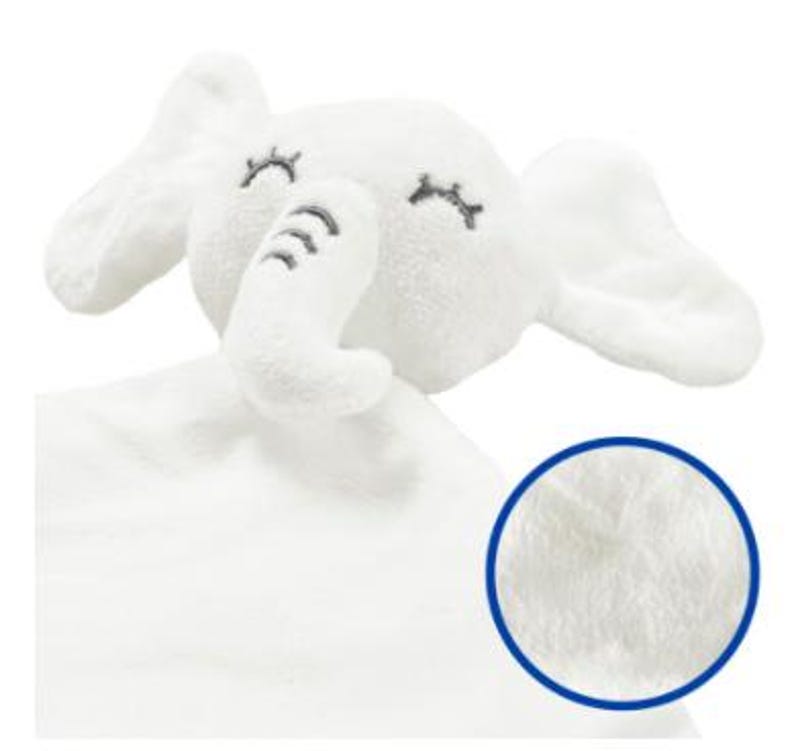 May include: A white plush elephant-shaped baby security blanket. The elephant has embroidered closed eyes and trunk details. The blanket has a soft, textured surface, perfect for a baby.