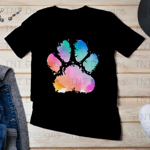 May include: Black t-shirt featuring a colourful watercolour paw print design.