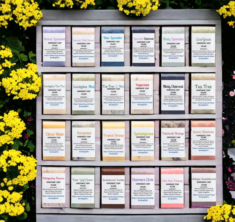 May include: A wooden shelf display with 24 bars of handmade vegan soap. The soaps are arranged in four rows of six bars each. The soaps are labeled with different scents, including Lavender, Tea Tree, Citrus Blast, and Bergamot.
