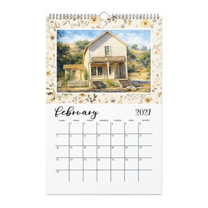 May include: A wall calendar for February 2021 featuring a top illustration of a wooden building labeled Olesons Mercantile. The calendar has a cream-colored border with a delicate brown floral pattern and a white grid for the month's dates.