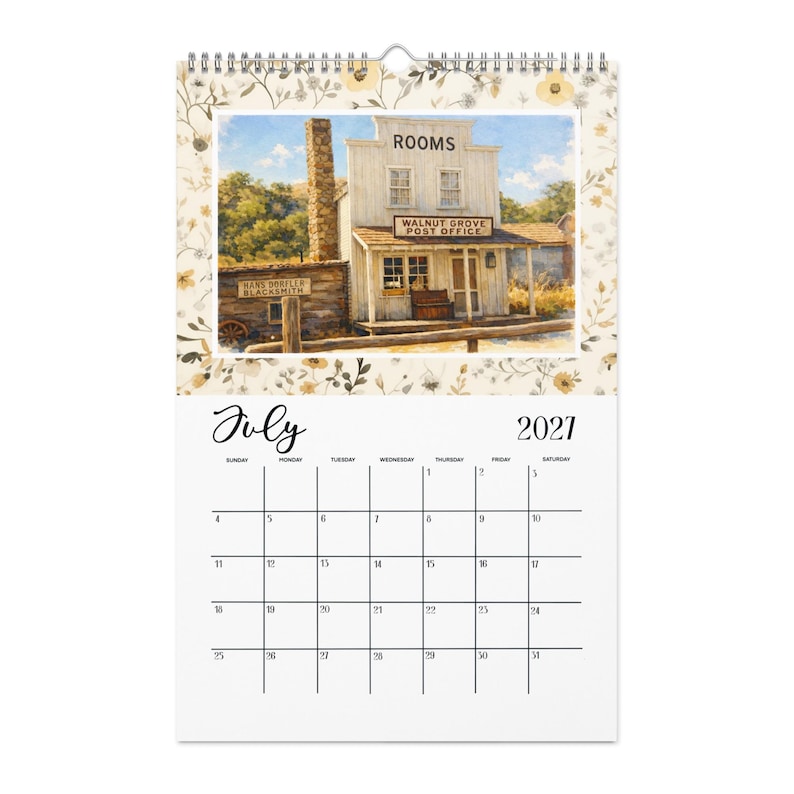 May include: A 2021 wall calendar for the month of July featuring a watercolor illustration of a historic building labeled ROOMS and WALNUT GROVE POST OFFICE, with a HANS DORFLER BLACKSMITH sign, surrounded by a floral border and wire binding.