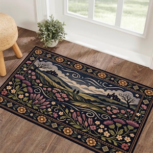 Può includere: Un tappeto rettangolare blu scuro con un design floreale e paesaggistico. Il tappeto presenta una scena paesaggistica centrale con dolci colline, alberi e un cielo nuvoloso. Il bordo è adornato con fiori nei toni del rosa, giallo e verde.