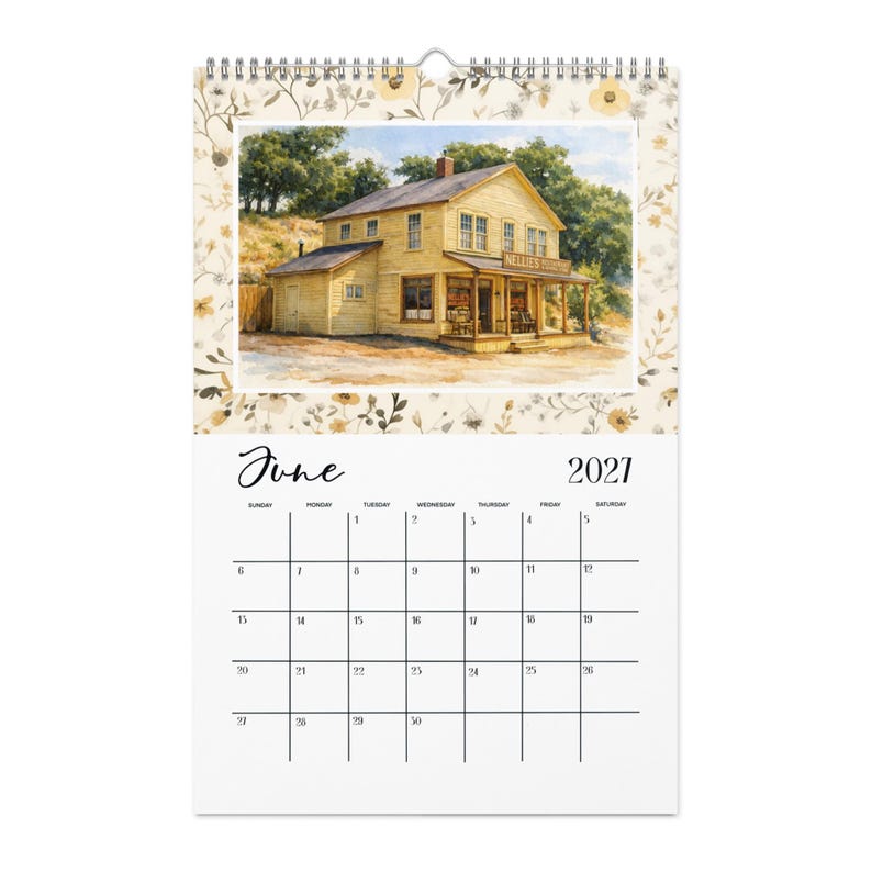 May include: A wall calendar for June 2021 featuring a watercolor illustration of a yellow two-story building with a porch and the sign Nellie's Tavern. The top border has a floral pattern in shades of beige, brown, and yellow on a cream background.