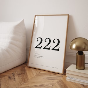 May include: A framed print with a white background and black text. The text reads "222" in a large font, followed by "Alignment" in a smaller font. The text continues with "You are in the right place & the right time." The bottom of the print reads "Angel Number".