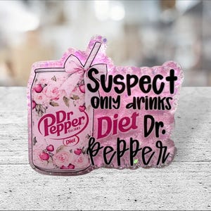 May include: A pink and glittery Dr. Pepper-themed acrylic charm. The charm features a Dr. Pepper can design with floral accents and the text "Suspect only drinks Diet Dr. Pepper". A pink bow and straw are also included.