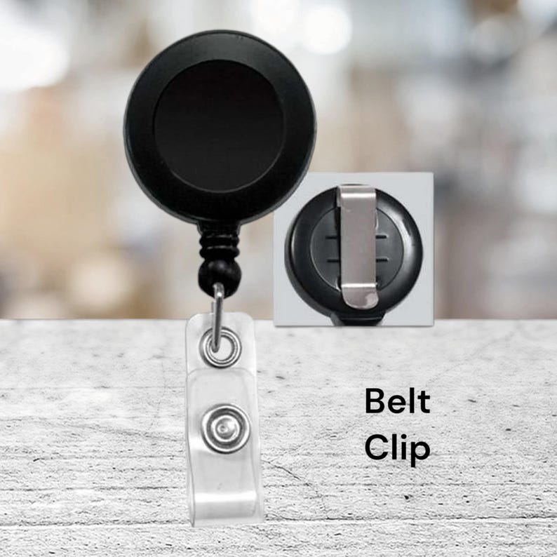 May include: Black retractable badge reel with a clear plastic clip and a black belt clip. The reel has a black plastic body and a silver metal clip.