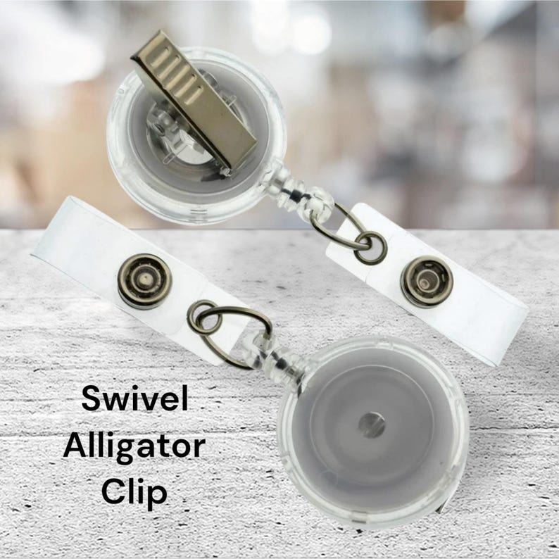 May include: Two clear plastic retractable badge holders with swivel alligator clips. The holders are attached to a clear plastic chain.