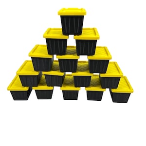 May include: A pyramid of small, black storage containers with bright yellow lids. The containers are stacked in a triangular formation, showcasing their compact size and design. The lids have a textured surface.