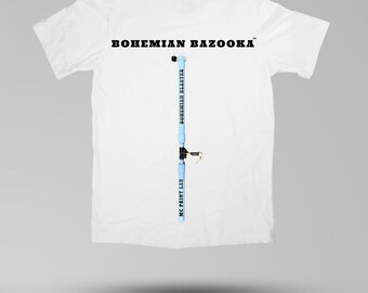 May include: White t-shirt with the text "BOHEMIAN BAZOOKA" across the top. A light blue design resembling a bazooka is printed vertically down the center. The text "BOHEMIAN BLASTER" and "MC PRINT LAB" are printed on the design.