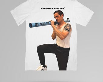 May include: White t-shirt with the text "BOHEMIAN BLASTER" and a graphic of a person holding a blue tube with "MC PRINT LAB" printed on it. The person is wearing a white tank top and black pants.