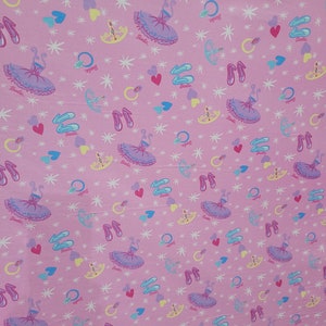 May include: Pink fabric with a repeating pattern of ballet tutus, ballet slippers, hearts, rings, and stars. The word "Barbie" is printed on some of the elements. The design features a light pink background with a variety of pastel colors.