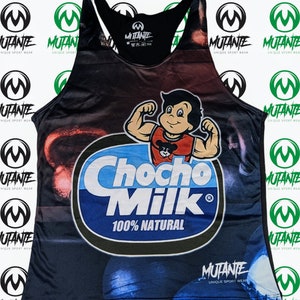 May include: A black tank top with a colorful graphic print of a cartoon character lifting weights and the text "Chocho Milk 100% Natural". The tank top has a black racerback design and the brand name "Mutante Unique Sport Wear" is printed on the bottom.