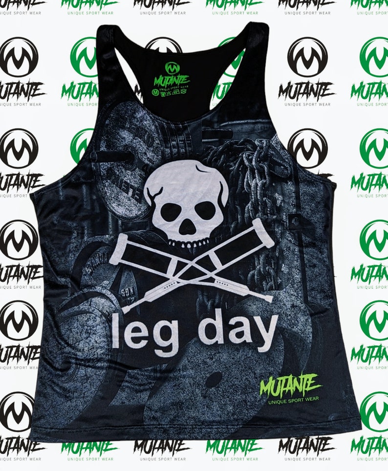 May include: Black tank top with a skull and crossbones graphic and the text "leg day". The tank top has a faded, distressed look and features a green and black "Mutante" logo.