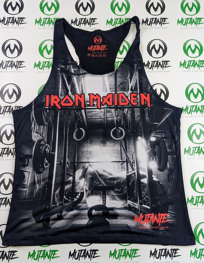 May include: Black tank top with a graphic print of a weightlifting gym scene. The text "IRON MAIDEN" is printed in red on the front of the tank top. The text "MUTANTE UNIQUE SPORT WEAR" is printed on the bottom of the tank top.