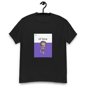May include: Black t-shirt with a white rectangle featuring a cartoon character and the text "Lil Tecca" in purple text.