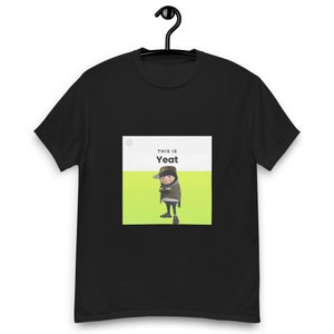May include: Black t-shirt with a white square graphic featuring a cartoon character with the text "This is Yeat" on a green background.