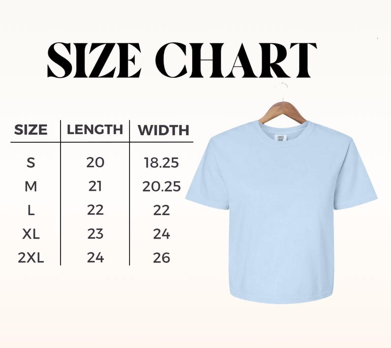 May include: A light blue t-shirt hangs on a wooden hanger. The image includes a size chart with measurements in inches for length and width, ranging from size small to 2XL. The text "SIZE CHART" is at the top.