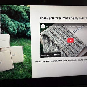 May include: A laptop screen shows a video about an eco-friendly loofah with a "Tire Tread" pattern. Three cardboard boxes, each labelled "HURKO", are stacked near a tree trunk and green foliage, suggesting a product packaging or delivery scene.