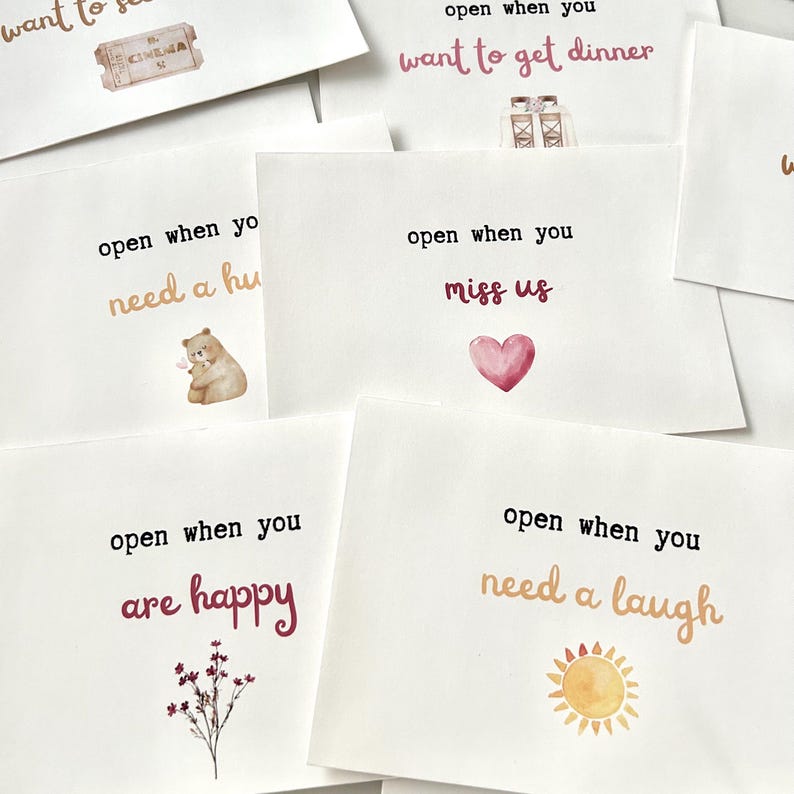 May include: A set of eight cards with watercolor illustrations and the text "open when you..." followed by a phrase like "need a hug", "miss us", "are happy", or "need a laugh".