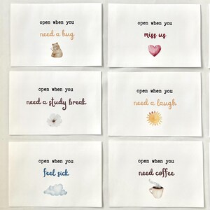 May include: Six white cards with watercolor illustrations and text. The cards read: "open when you need a hug", "open when you miss us", "open when you need a study break", "open when you need a laugh", "open when you feel sick", and "open when you need coffee".
