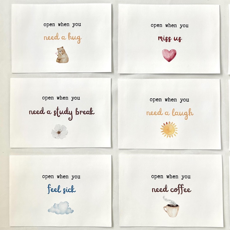 May include: Six white cards with watercolor illustrations and text. The cards read: "open when you need a hug", "open when you miss us", "open when you need a study break", "open when you need a laugh", "open when you feel sick", and "open when you need coffee".