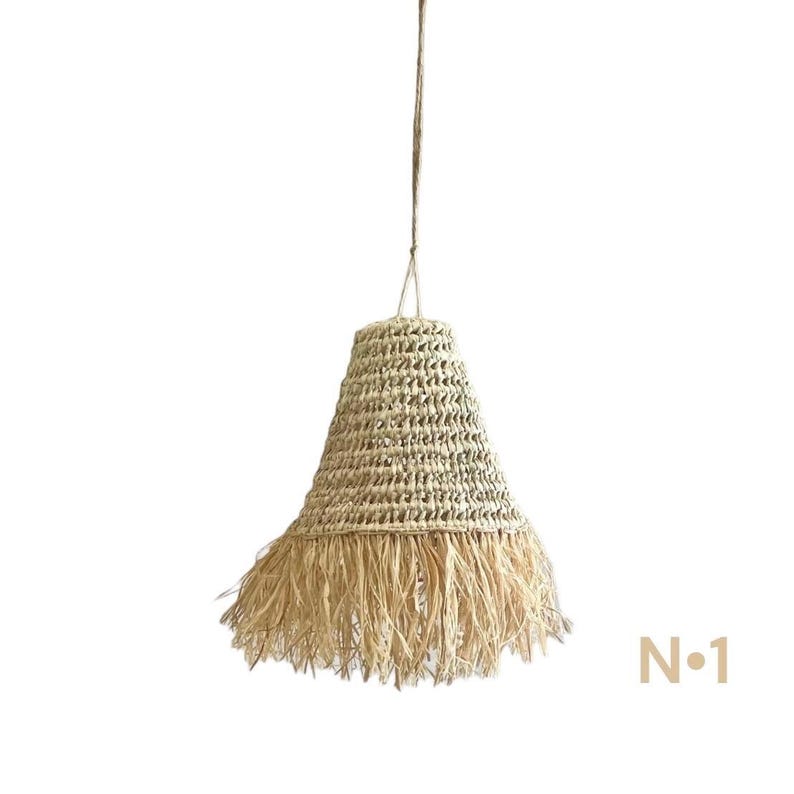 May include: A natural woven pendant light with a fringed bottom. The light is made of a light brown material and has a bell shape.