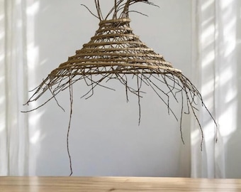 May include: A large, woven, conical lampshade with a natural brown color. The shade is made of thin, natural twigs that extend beyond the woven base, creating a unique and rustic look.