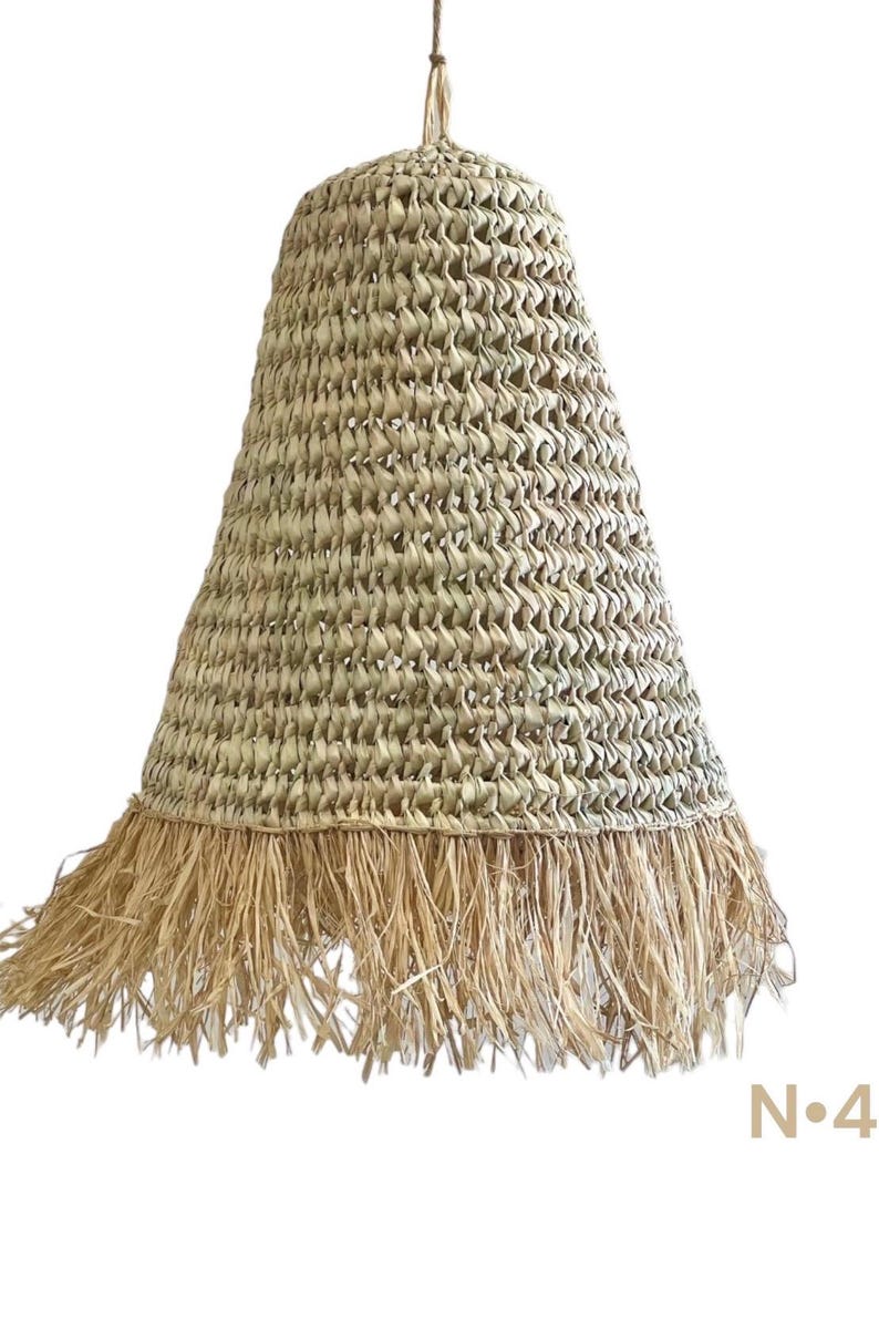 May include: A natural woven pendant light with a fringe trim. The light is made of a light brown material and has a bell shape.