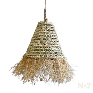 May include: A natural woven pendant light with a fringed bottom. The light is made of a light brown material and has a cone shape.