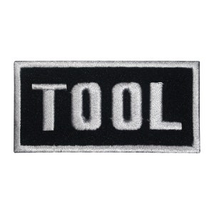 May include: Black and white embroidered patch with the word "TOOL" in white lettering.